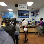 Hold Hell Isn’t Accidental – It’s Policy customers waiting in line at a store customer service counter