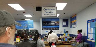 customers waiting in line at a store customer service counter