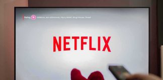 Netflix Swinging Axe – Why Now? TV screen displaying Netflix with person holding remote