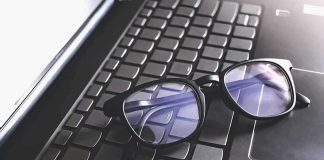 Meta’s Wild Giveaway Stuns Veterans Black eyeglasses resting on a laptop keyboard