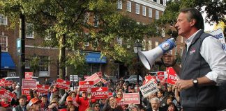 Speaker with megaphone addresses campaign rally crowd