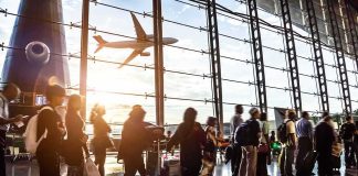 Airport Carnage Rocks Saudi Hubs Passengers queue inside an airport terminal at sunset