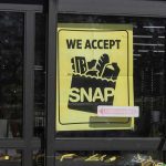 store window sign stating SNAP acceptance