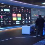 120-Day War Overhaul – Elon Musk At Helm cybersecurity operations room with large data dashboards and people discussing