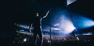 Kacey’s Columbus Blast – Wynonna Fires Back Singer on stage facing a large concert crowd